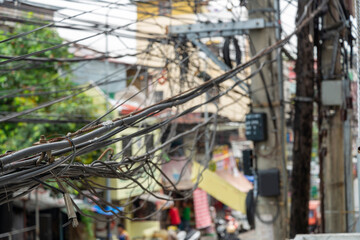Tangled mess of eletrical cables,outdoors and above the streets of Manila,Philippines.