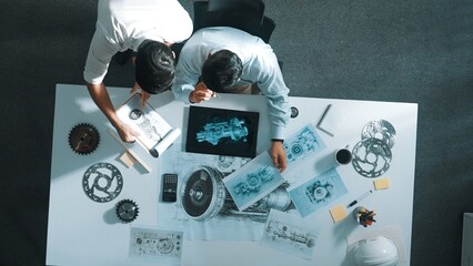 Top down aerial view of manager sitting while answer question about jet engine. Professional...