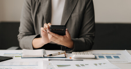 Businesswoman Analyzing Data on Smartphone 
