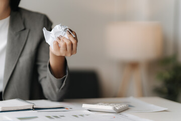 The Weight of Deadlines: A businesswoman grapples with a challenging task, a crumpled paper ball...