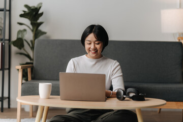Smiling Woman Working from Home on Laptop 