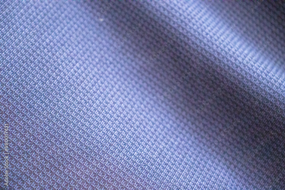 Poster close-up of a textured fabric in soft hues of blue, showcasing intricate patterns and textures, idea