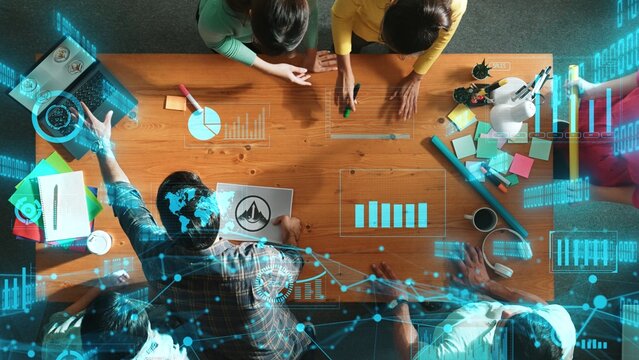 Top view of skilled business team put graphic logo on meeting table with colorful sticky notes and start to design while explain idea. Smart project manager explain about financial graph. Symposium.