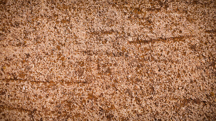 A textured stone background featuring earthy beige and brown tones, perfect for natural designs, creative backdrops, and rustic themes