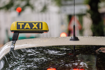 Munich, Germany - September 13, 2024 - a close-up of a yellow taxi sign on top of a car, with...