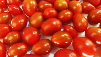 Closeup ripe red cherry tomatoes.
