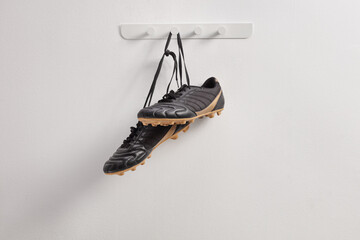 Black football cleats hanging