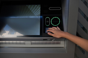 ATM user enters PIN, child's hand presses button on ATM, importance secure transactions Secure...