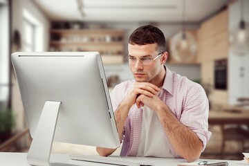 A focused, thought freelance worker with laptop