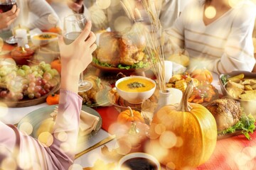 Friends having dinner at festive table on Thanksgiving Day