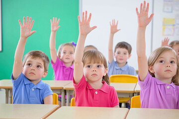 kindergarten students raising hands to answer a question, sitting attentively at desks