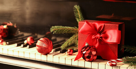 Red Christmas balls and gift box on piano keys