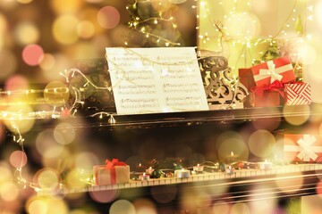 Piano with Christmas decorations and gift boxes in room