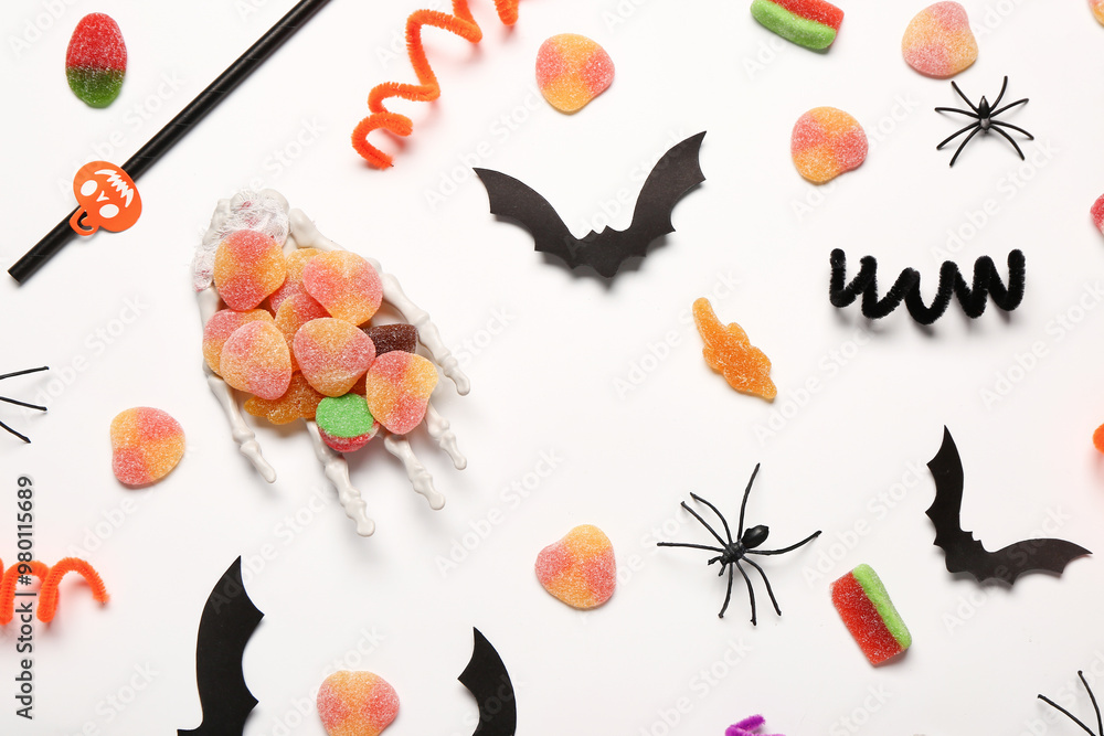 Wall mural Composition with sweet jelly candies and Halloween decorations on light background