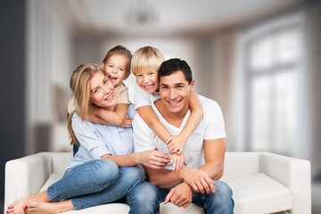 Happy young family posing together at home