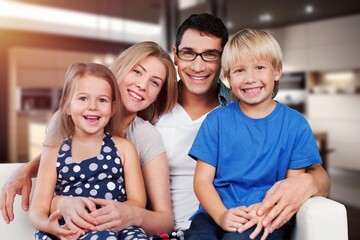 Happy young family posing together at home