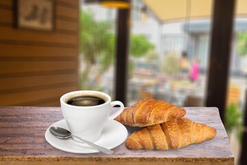 Fresh tasty croissants and coffee in modern kitchen
