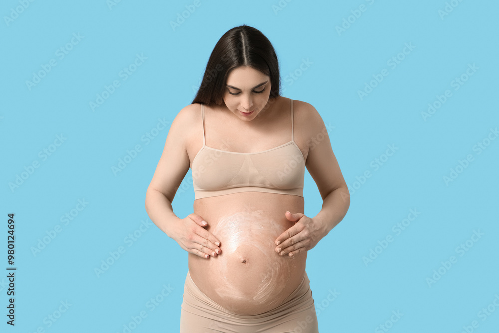 Sticker Beautiful pregnant woman with cream on her belly against color background