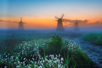 Sunrise at the windmill during a foggy morning