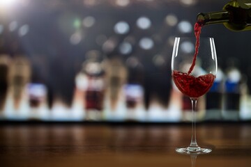 Bottle and glass of sweet alcohol red wine