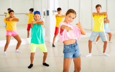 Fototapeta premium Group of active children dancing hip-hop dance in studio.