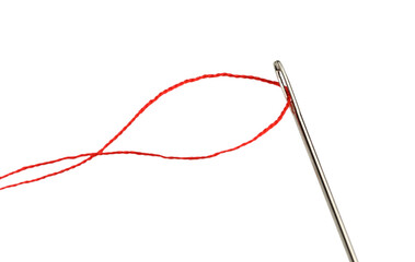 Sewing needle with red thread isolated on white