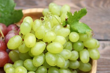 Fresh ripe grapes on wooden table, closeup