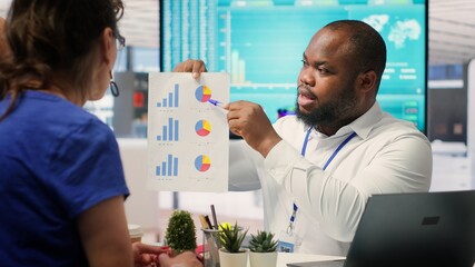 Mature couple asking for professional financial advice from banker expert, discussing strategy for...