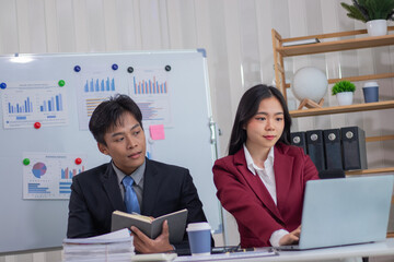 Young businessman takes out a pen and notebook to record the meeting. and analyze the company's profits