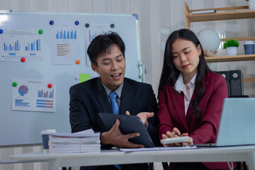 A business couple analyzes the cost of a company's bracelets.