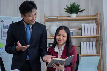 A business couple analyzes the cost of a company's bracelets.