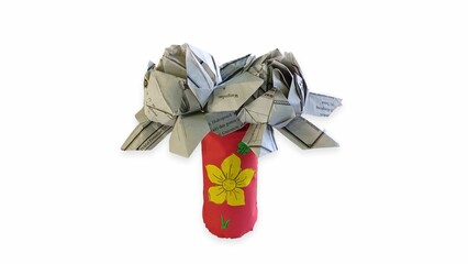 handicrafts from paper and old newspapers in the shape of flowers by elementary school children