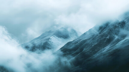 misty mountain range partially obscured by clouds as rain falls gently across the slopes