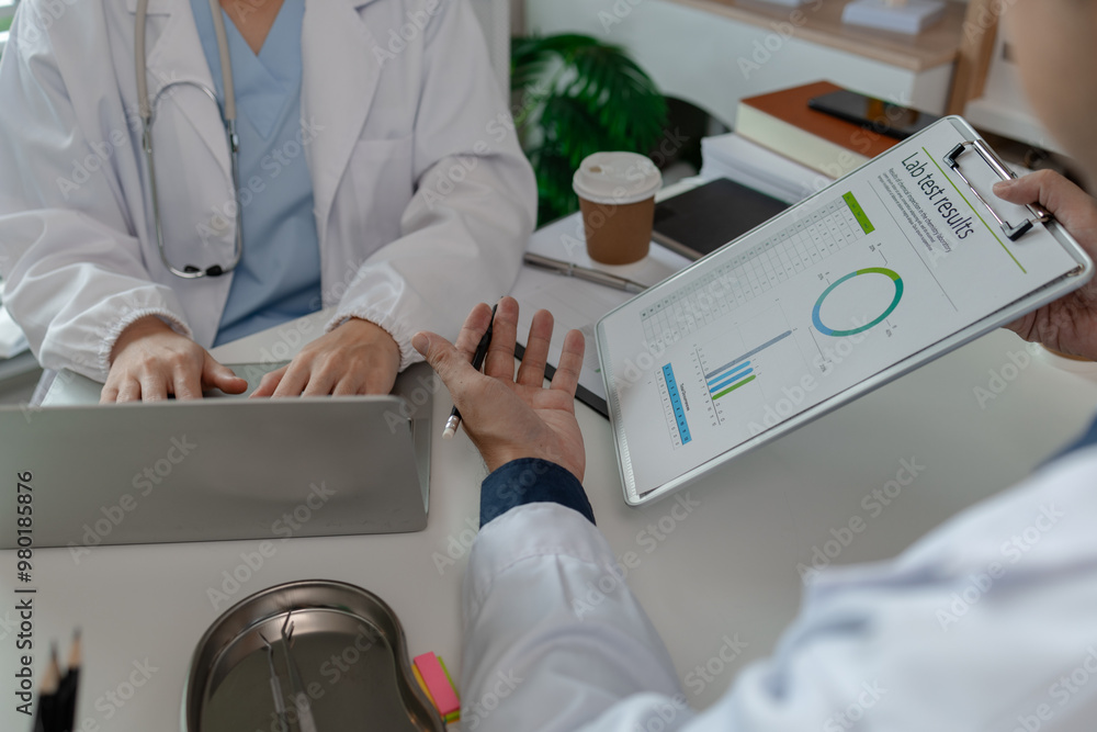 Wall mural two doctors sat in a private office at the hospital discussing and exchanging knowledge with each other, doctors discussed the way that would be the most appropriate treatment, stethoscope, specialist