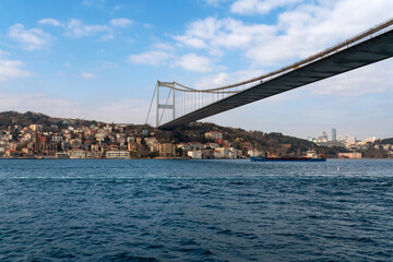 View of Sultan Mehmed Fatih Bridge and the embankment of the European part of Istanbul from the water area of the Bosphorus on a sunny day, Istanbul, Turkey