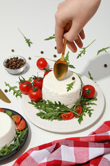 Ricotta in a bowl with fresh tomatoes and herbs