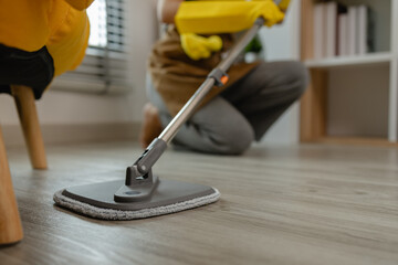 she is mopping floor in living room, as a wife she love to keep the house clean to make sure...