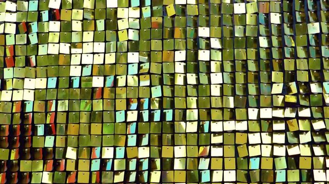 Shiny gold yellow metal mosaic in the shape of squares, disco texture beautiful background.