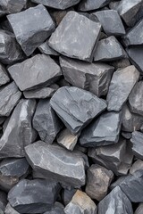 A close-up view of various textured black stones, ideal for backgrounds or natural design projects.