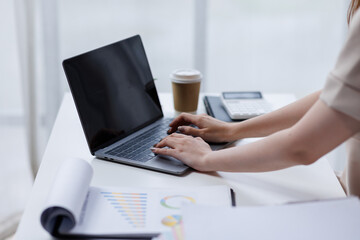 Businesswoman working at office with documents on his desk, doing planning analyzing the financial report, business plan investment, finance analysis concept	
