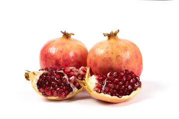 open pomegranates, and pomegranate seeds isolated on white background.