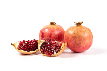 open pomegranates, and pomegranate seeds isolated on white background.