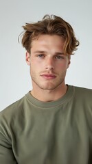Fototapeta premium Hopeful expression of a young man: fashion portrait for posters and cards