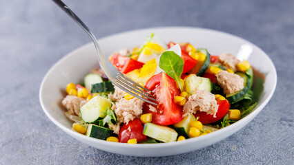 Mixed Salad with Egg, Tomato, Corn, Cucumber, and Tuna – Healthy Meal with Fork