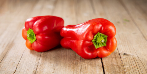 Two Red Peppers on Wooden Background – Fresh and Organic Vegetables