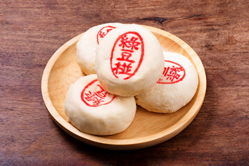 Mung bean cake on the plate,the Chinese words on the moon cake is 'mung bean cake', not a logo or trademark.