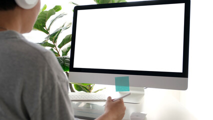 Man using desktop computer with blank screen for mock up template background, people business technology and lifestyle background concept