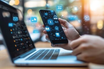 Modern Digital Life: Hand Using Smartphone With Laptop Nearby