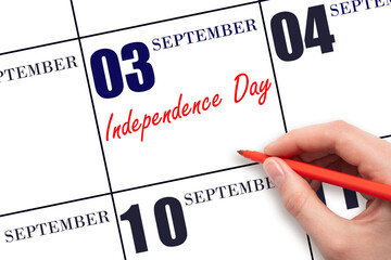 September 3. Hand writing text Independence Day on calendar date. Save the date.