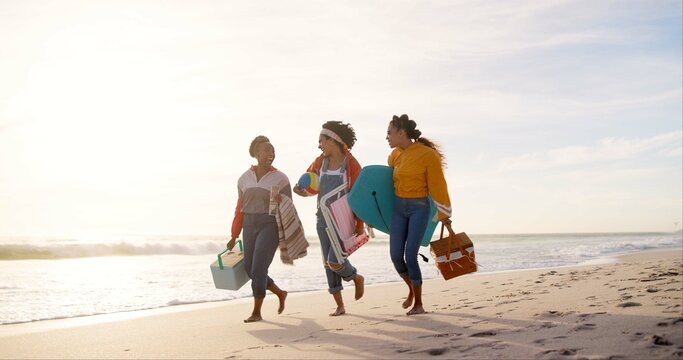 Happy, picnic and girl friends on beach for weekend trip, vacation or travel with bonding together. Walking, adventure and group of young women laughing by ocean for seaside tropical holiday.